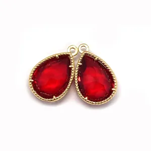 Pair of deep red faceted pear-shaped natural stone pendants with gold metal edges