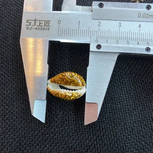 Detailed size measurement of a 1.8cm golden glitter coated natural cowrie shell bead