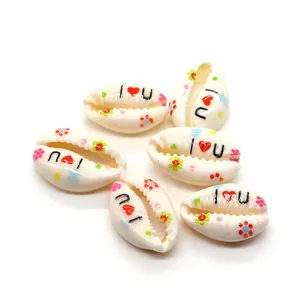Macro detail of natural cowrie shell beads with colorful flowers and I Love You prints