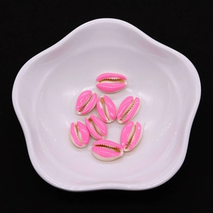 Macro shot of pink enamel conch shell beads 9x19mm for DIY jewelry making and decor