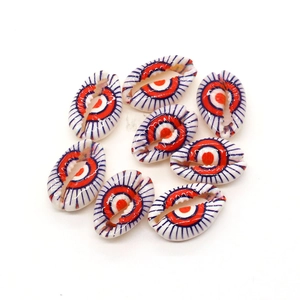 Detailed close-up of natural shell beads with hand-painted evil eye patterns for DIY jewelry