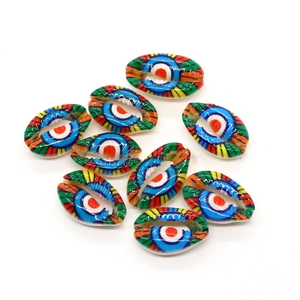 Close-up of nine colorful hand-painted evil eye patterns on natural cowrie shell beads