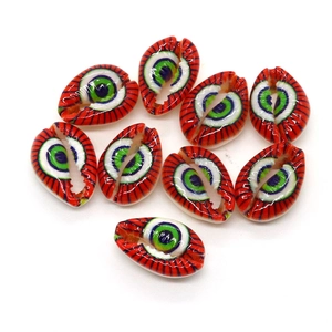 Macro detail of nine red natural shell evil eye beads for DIY jewelry making
