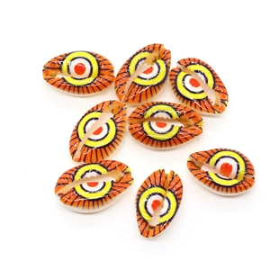 Macro shot of hand-painted evil eye patterns on natural seashell beads for DIY jewelry