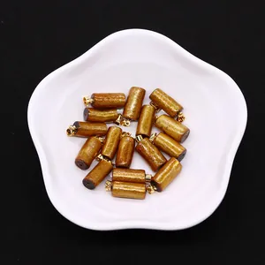 Macro detail of cylindrical coral-style pendants with gold plating for jewelry making