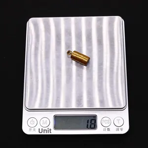 Detailed view of cylindrical gold coral pendant on a digital scale weighing 1.8 grams