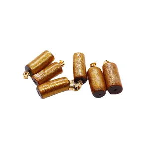 Cylindrical golden coral pendant with brown grain texture and polished metal buckle for DIY jewelry
