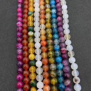 Detail shot of multicolor natural agate round beads with unique dragon vein textures