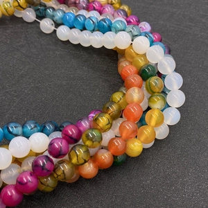 Macro detail of colorful agate round beads with natural stone texture for DIY jewelry