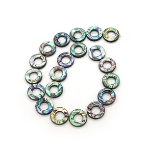 Natural abalone shell donut beads in a spiral arrangement for DIY necklace jewelry