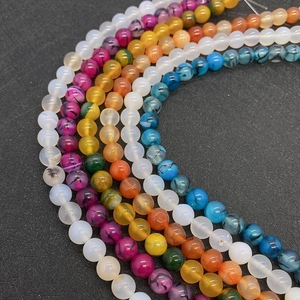 Macro shot of colorful 6-10mm round agate beads for DIY jewelry making on black background