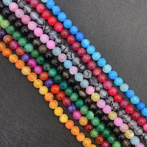 Macro detail of colorful dragon vein agate round beads with natural cracked textures