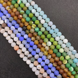 Macro detail of multi-color striped silk agate round beads with natural banded textures