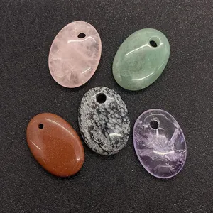 Detailed view of oval natural gemstone pendants in amethyst, quartz, and aventurine stones