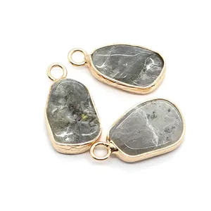 Irregular natural stone pendants with gold plated edges and spotted grey marble texture