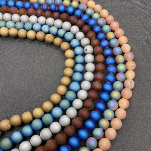 Macro shot of colorful frosted matte agate beads with textured metallic sandblasted finish