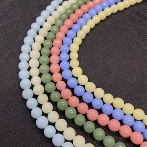 Macro shot of 6-10mm colorful round natural stone beads for DIY jewelry making in five hues