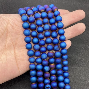 Macro view of blue druzy agate beads with a metallic rainbow coating for DIY jewelry