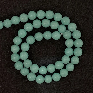 Close-up of polished light green natural stone beads for DIY jewelry making accessories