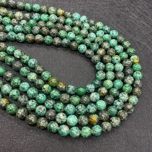 Detailed view of polished natural green African turquoise beads for DIY jewelry making