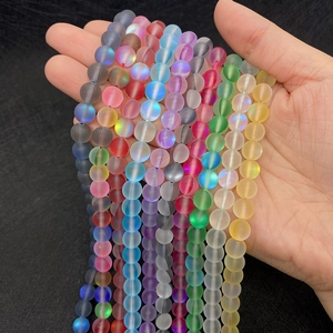 Close-up of matte iridescent synthetic moonstone round beads for DIY jewelry making