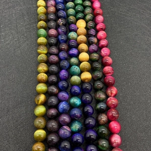 Macro detail of vertical gemstone bead strands with cat eye effect and silky polished finish