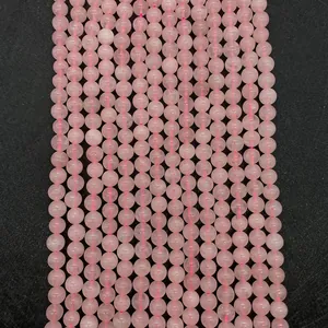 Macro shot of natural pink quartz round beads for DIY jewelry making and necklaces
