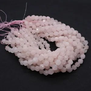 Macro view of faceted rose quartz round beads with smooth pink finish for jewelry DIY