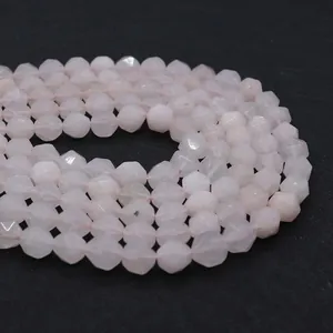 Macro shot of faceted pink rose quartz beads showing the detailed geometric cut surface