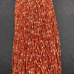 Macro detail of faceted red agate beads for DIY jewelry making with natural texture