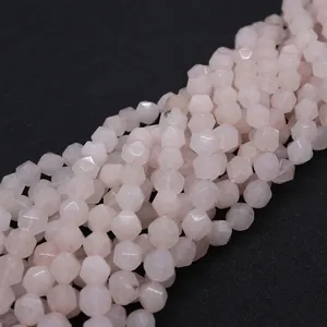 Detail of faceted rose quartz beads showing precise polyhedron cut and soft pink texture