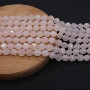 Macro shot of faceted natural rose quartz beads with diamond cut surface for DIY jewelry