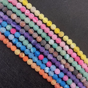 Macro shot of colorful weathered agate round beads with natural cracked dragon vein textures