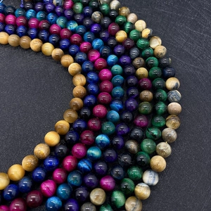 Macro detail of mixed color tiger eye stone beads showing natural grain and cat eye effect