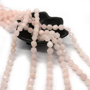 Faceted rose quartz beads strands on a black porcelain dish for DIY jewelry making