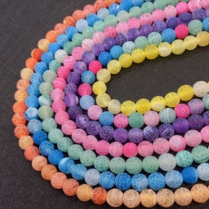 Macro shot of colorful dragon-vein weathered agate beads arranged in a spiral for DIY jewelry