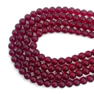 Macro detail of natural garnet round beads with deep red luster and smooth texture