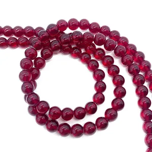 Macro shot of polished deep red garnet round beads with glossy finish for jewelry making