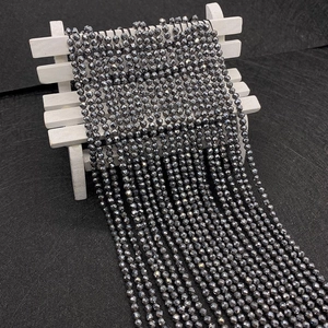 Macro shot of 2-4mm faceted hematite stone beads with metallic grey luster for DIY jewelry