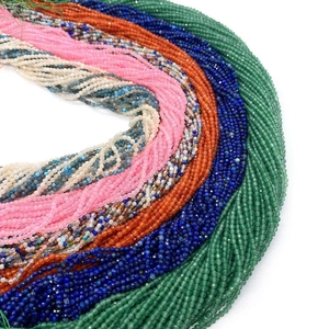 Close-up of faceted 2-3mm natural gemstone beads like lapis and garnet for DIY jewelry
