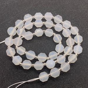 Macro shot of octagonal faceted milky white opal loose beads with clear spacers for DIY