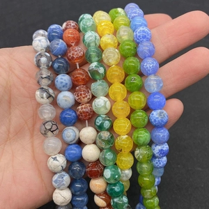 Close-up of colorful cracked fire agate round beads for DIY jewelry making