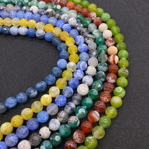 Macro shot of colorful dragon vein agate beads showing unique cracked textures for DIY jewelry