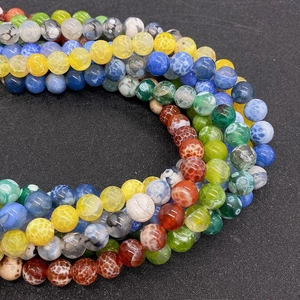 Macro shot of colorful dragon vein agate round beads with detailed crackle textures