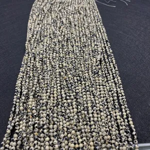 Macro view of 2-4mm faceted Dalmatian Jasper beads with natural spotted texture for DIY