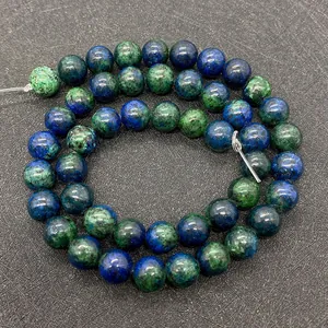 Macro detail of natural phoenix lapis round beads with blue and green mineral patterns