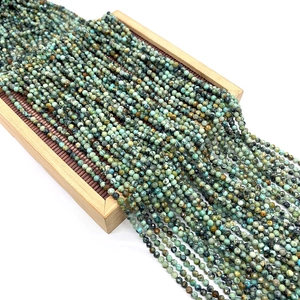 Faceted African Turquoise round beads for DIY jewelry making on a bamboo display stand