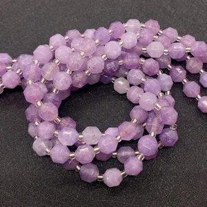 Macro shot of faceted lavender amethyst beads showing light reflections and texture