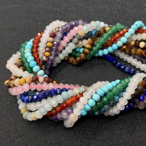 Macro shot of colorful faceted natural stone beads featuring amethyst and jasper textures