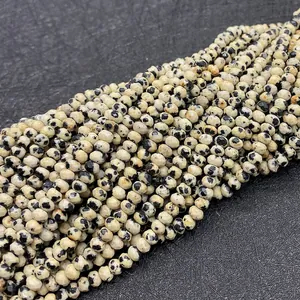 Macro detail of faceted Dalmatian Jasper beads for DIY jewelry making with spot pattern